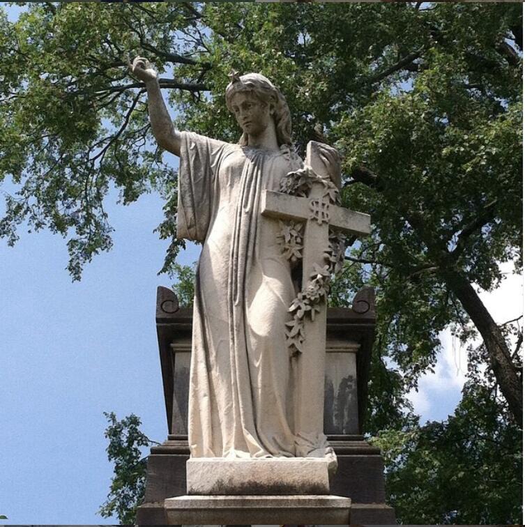 angel statue holding cross