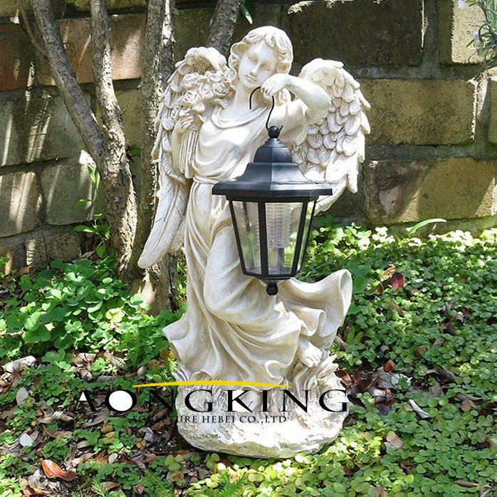angel statue with lamp