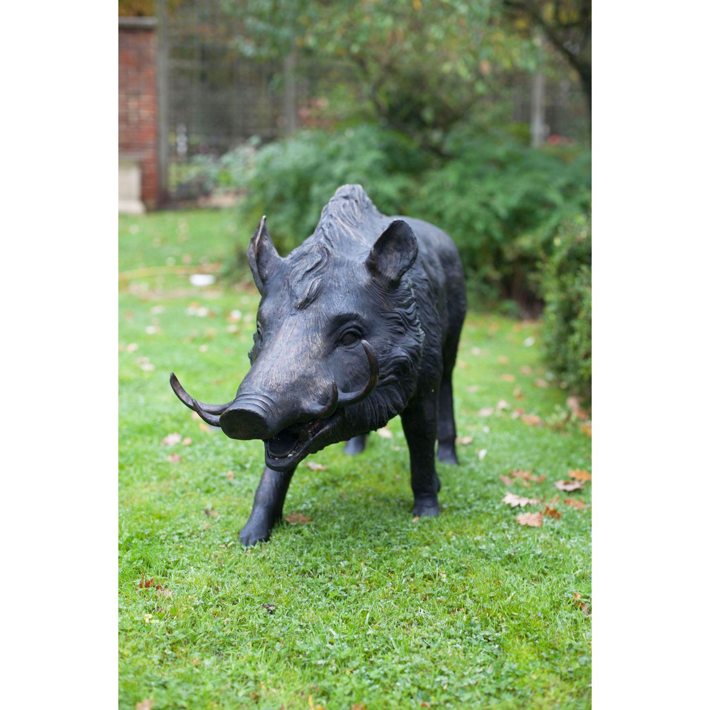 Black pig standing on the lawn bronze statue