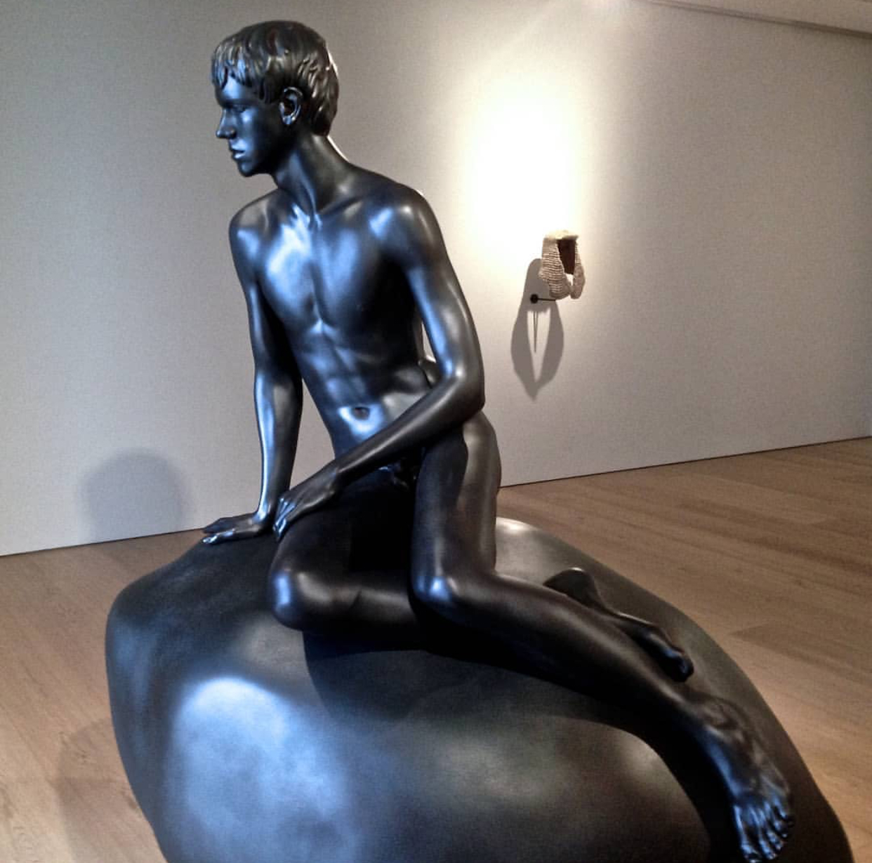 Black sculpture of classic seaside boy