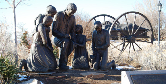 Bronze handcart pioneer family statue stan watts
