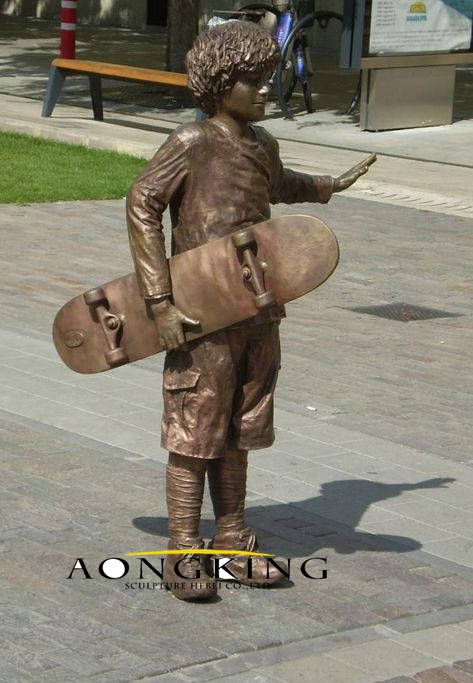 Bronze statue of little boy with a scooter