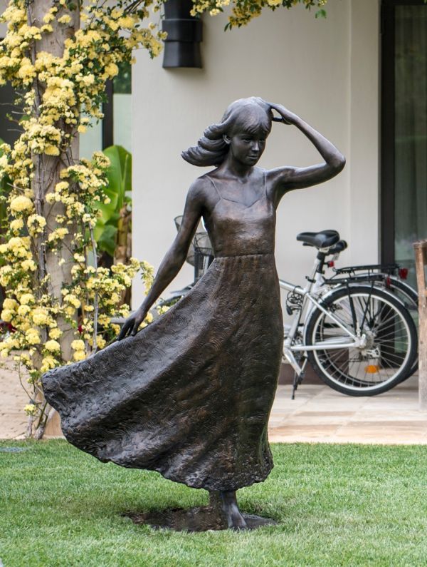Garden statue of anthony smith girl with flowing dress for yard
