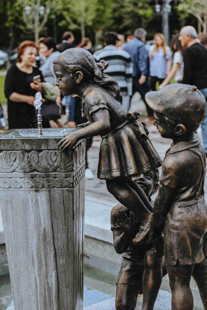 Sculpture of children drinking water