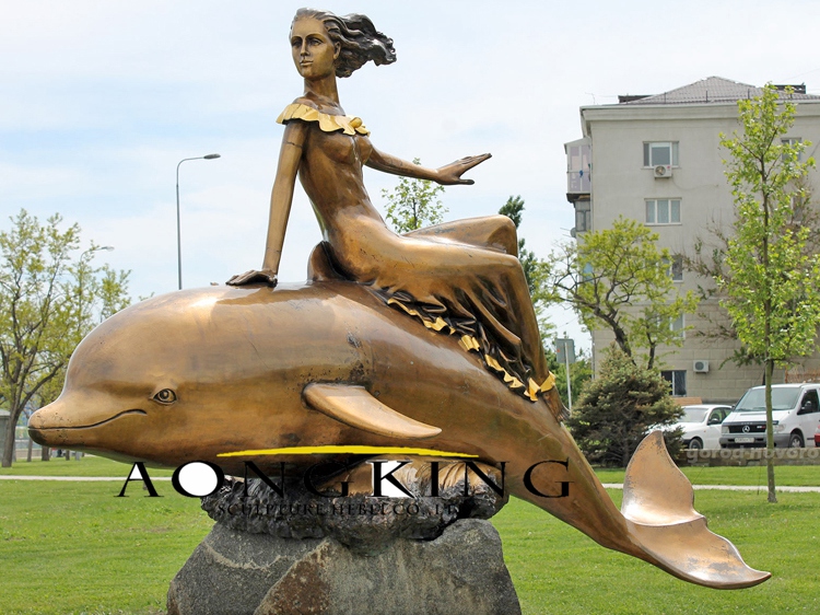 Statue of a girl riding a dolphin