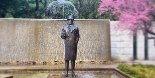modern art fountain man in the rain