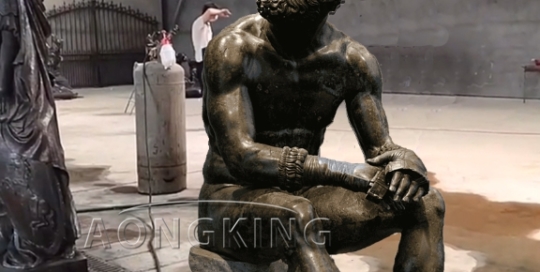 Resting boxer bronze statue