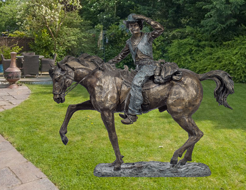 bronze cowboy on horse statue