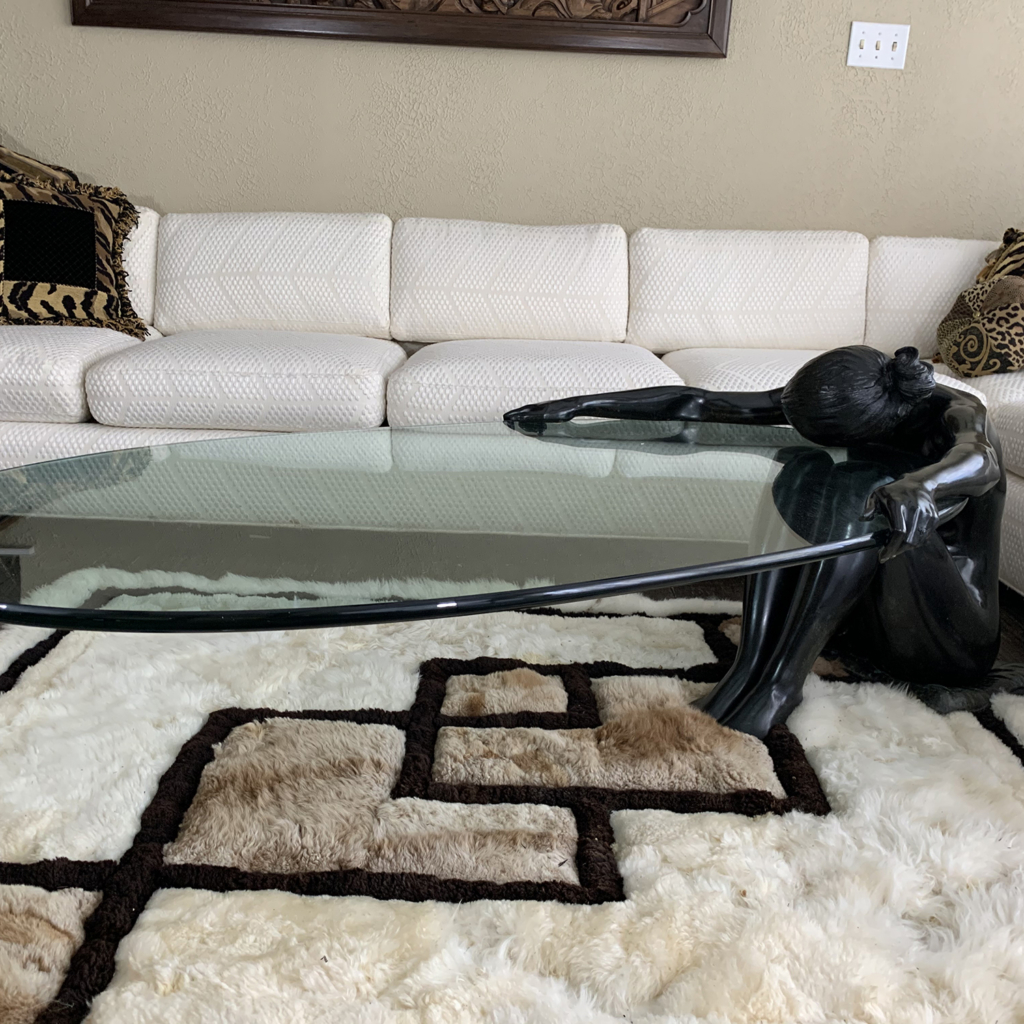 A modern bronze coffee table modelled as a seated nude woman