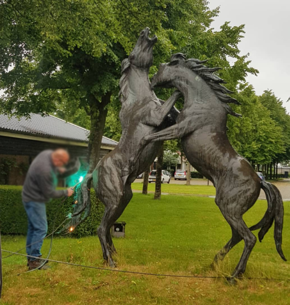 Two bronze fighting horse sculpture