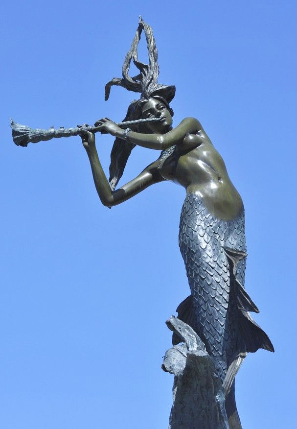 Mermaid playing flute sculpture