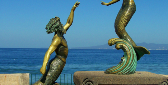 a couple mermaid statues
