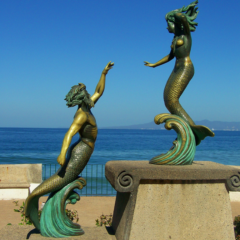 a couple mermaid statues
