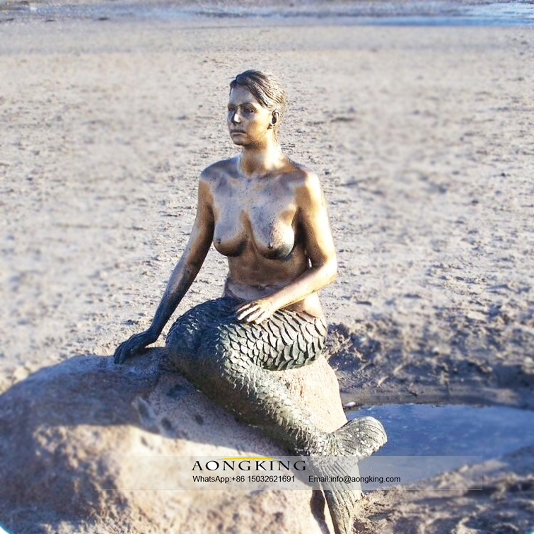 Life size bronze sitting nude female mermaid