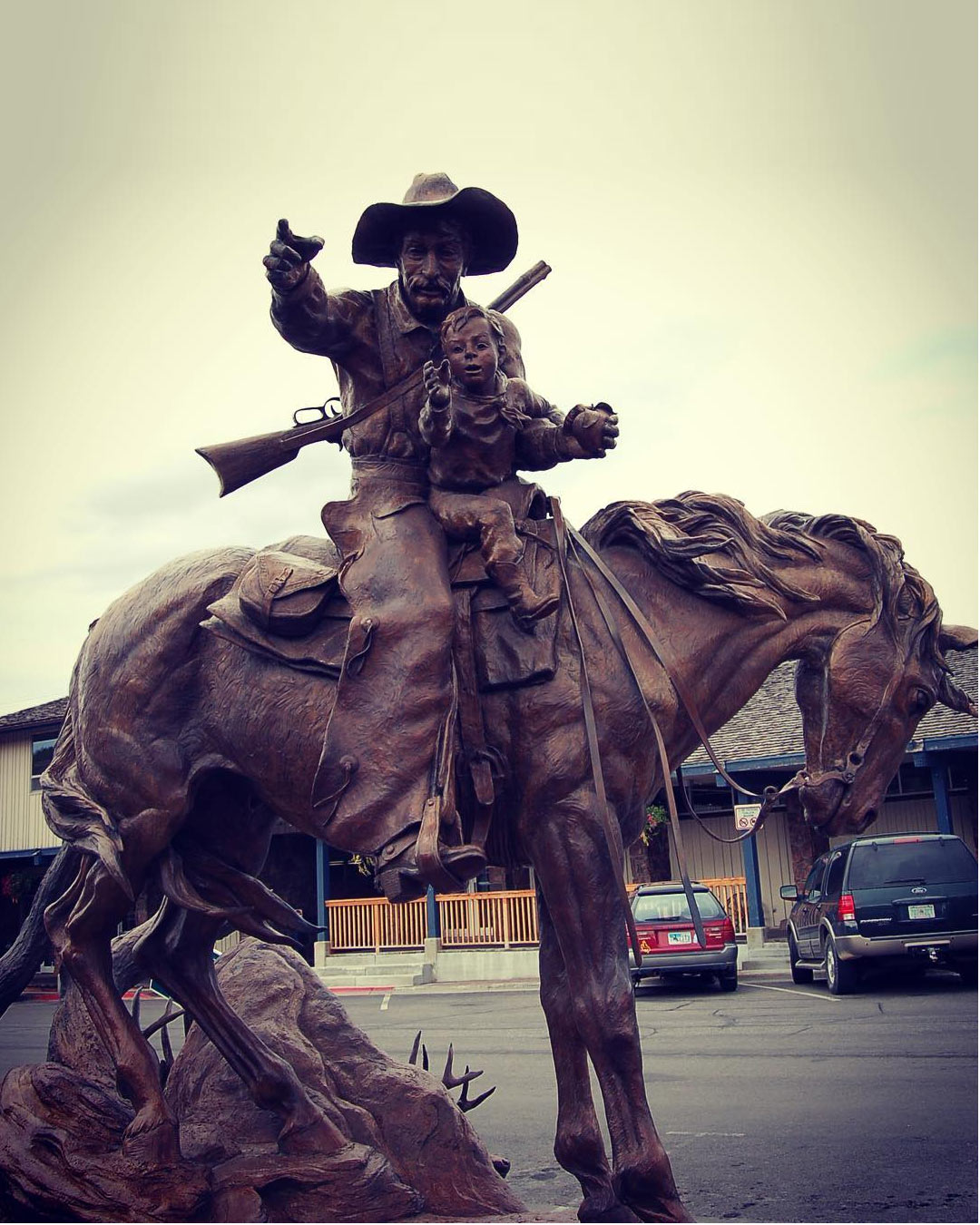 cowboy riding horse statue
