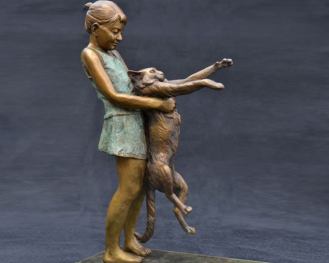 statue of girl with cat