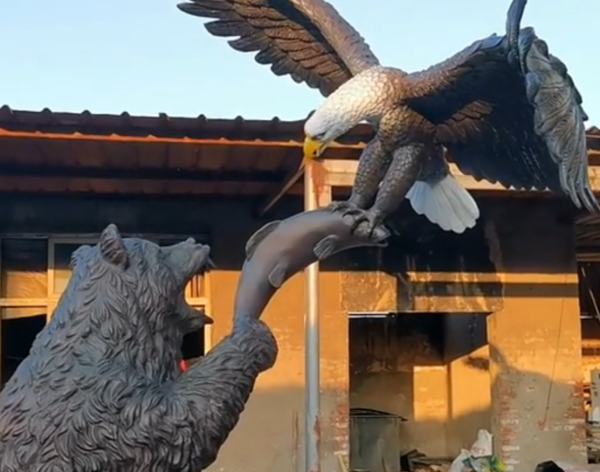 cute fighting bear and eagle statue