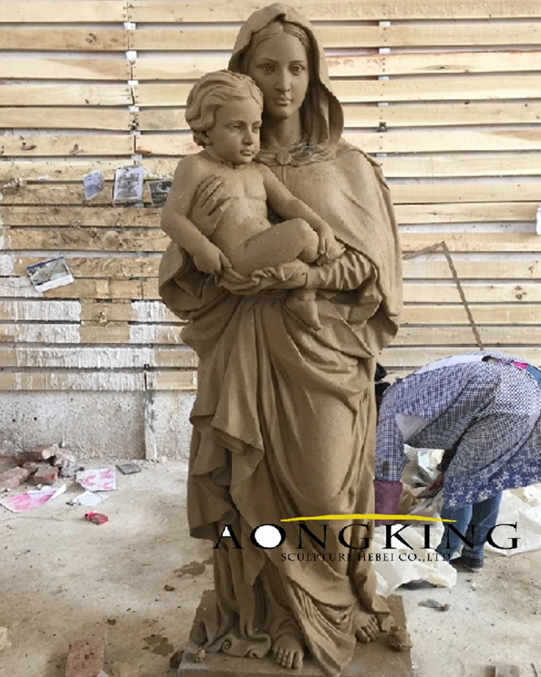 moulding clay for hand casting Virgin Mary statue with baby Jesus