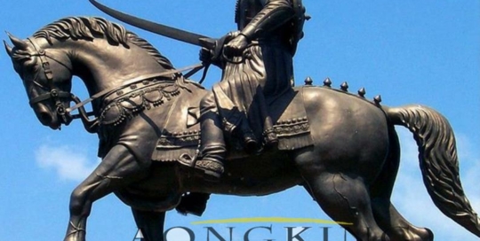 sculpture of man riding horse