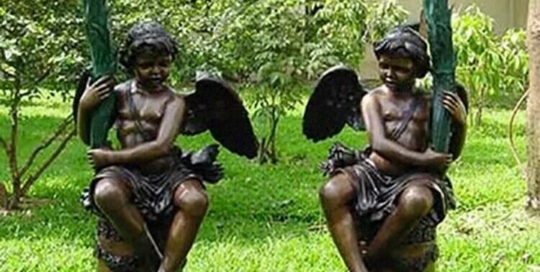 a pair of angel lamp sculptures