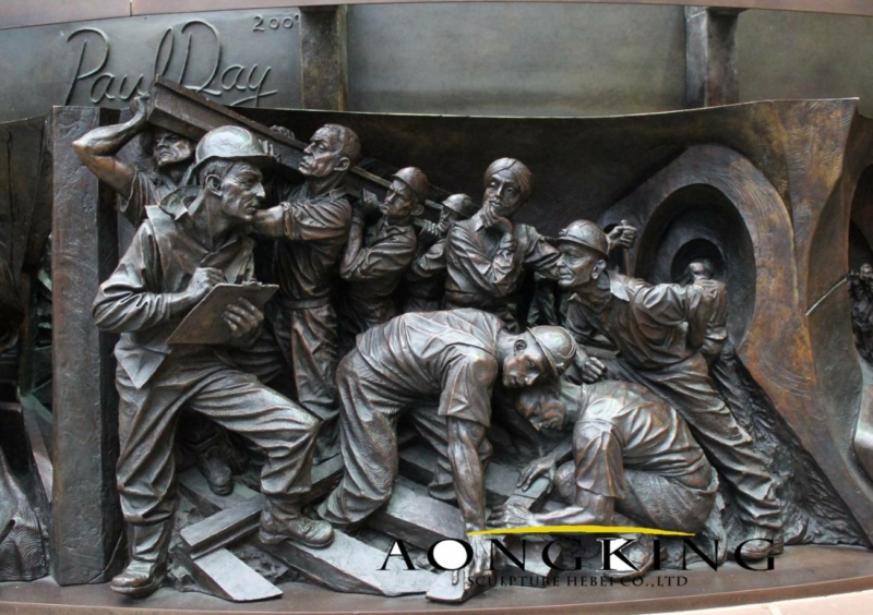 bronze statue of Bas relief in St Pancras Train Station