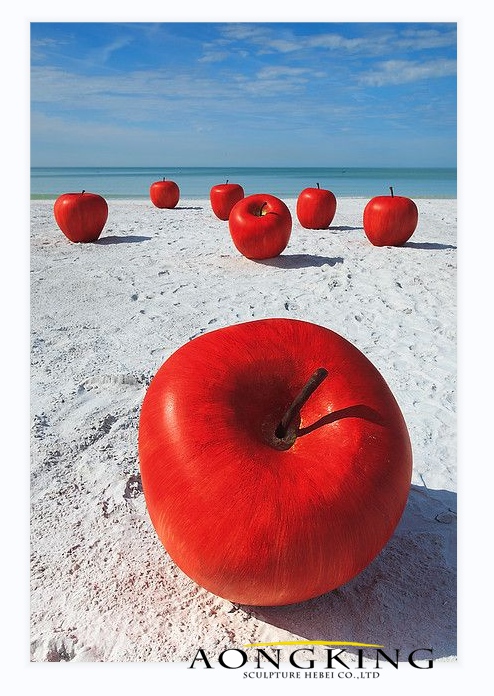 painted stainless steel apples statues on the beach